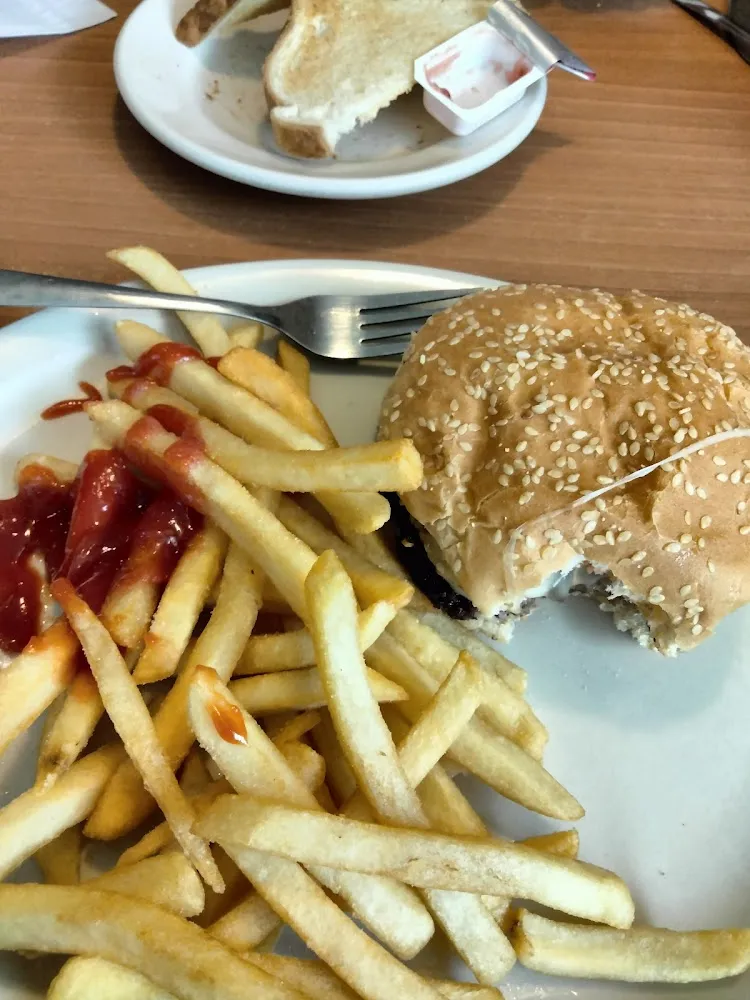A Bacon Third Pound Cheeseburger and French Fries with Ketchup
